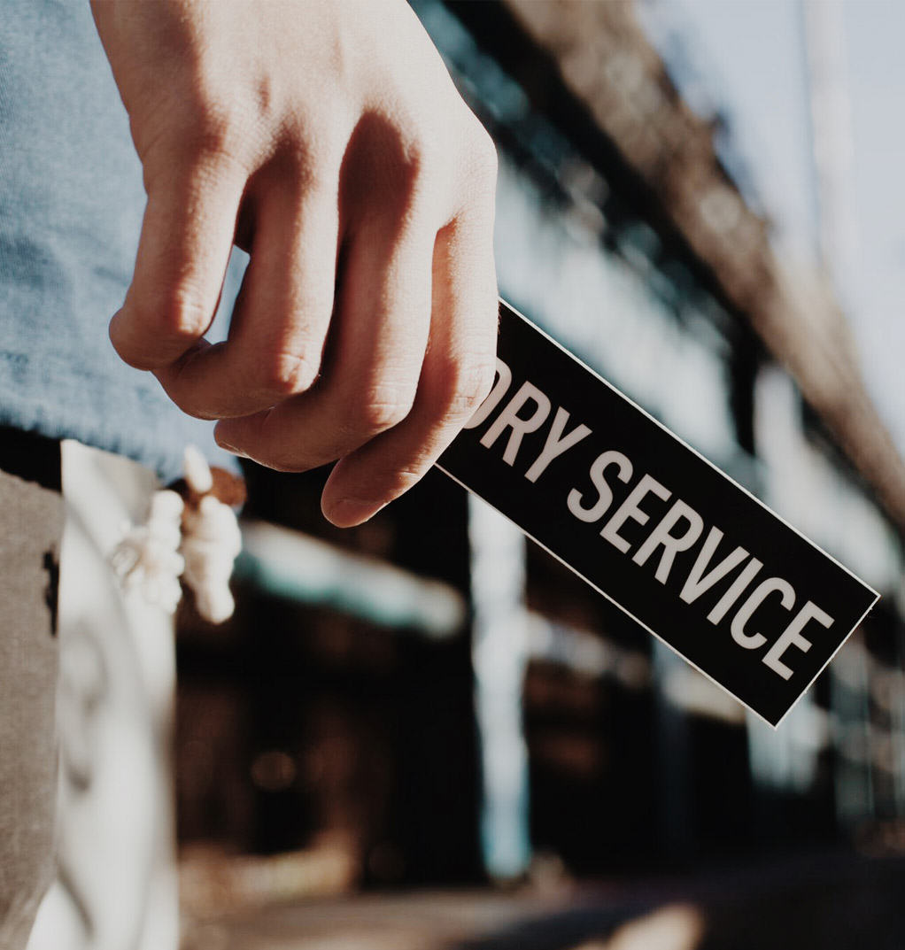 Person holding a Laundry Service sticker